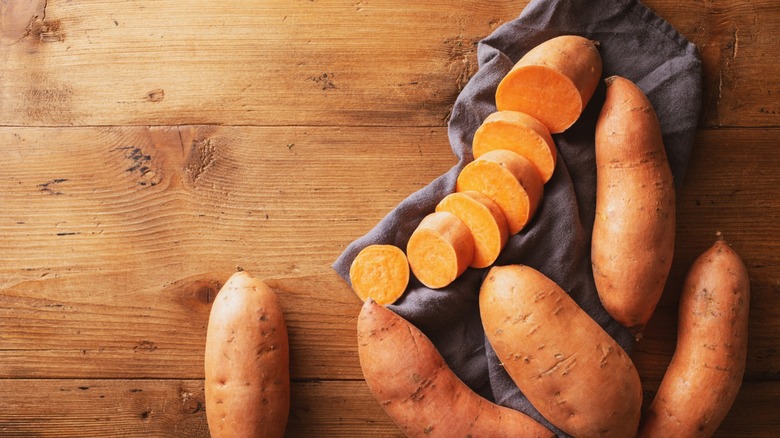 sweet potatoes on wooden slab