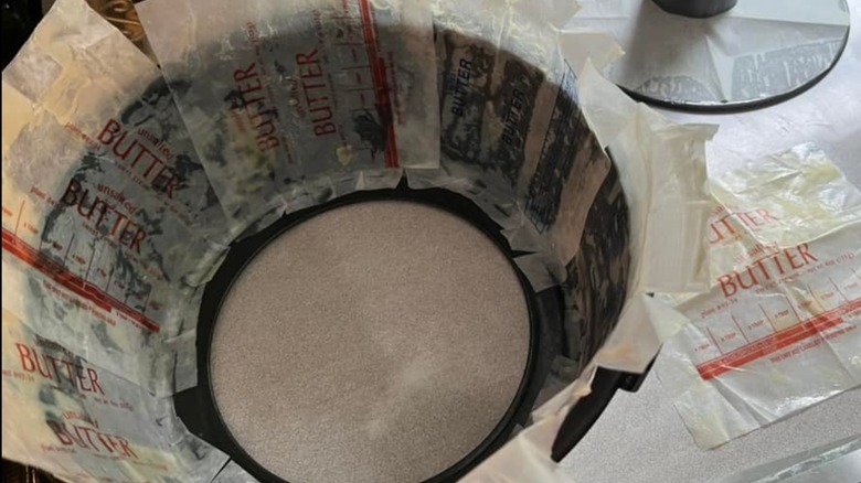 A baking tin lined with butter wrappers