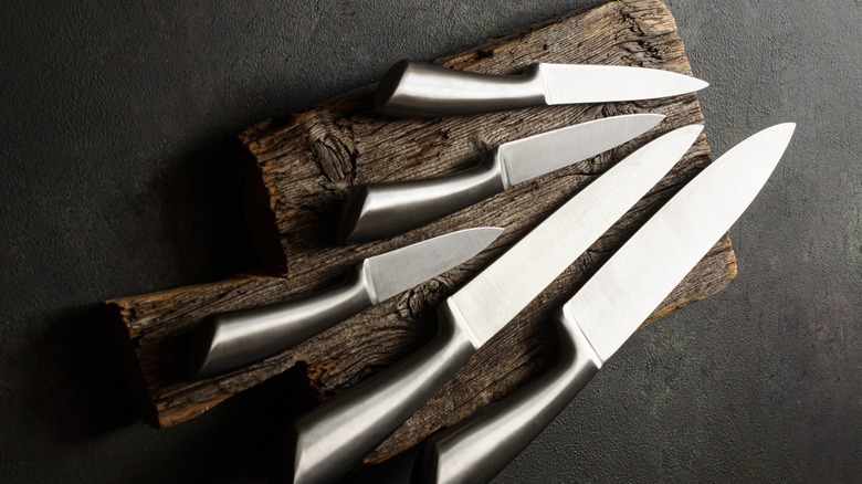 Set of kitchen knives on a chopping board
