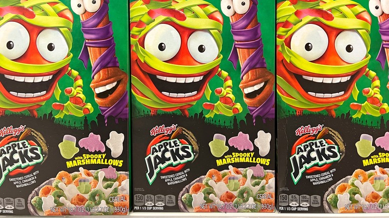 Grocery store shelf with boxes of Kellogg's brand Apple Jacks cereal with spooky Marshmallows.