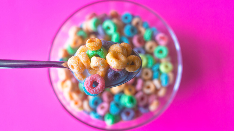 Bowl of colorful breakfast cereal on pink background