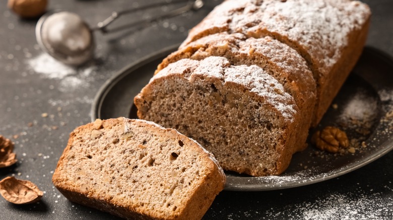 black walnut loaf dusted with powdered sugar