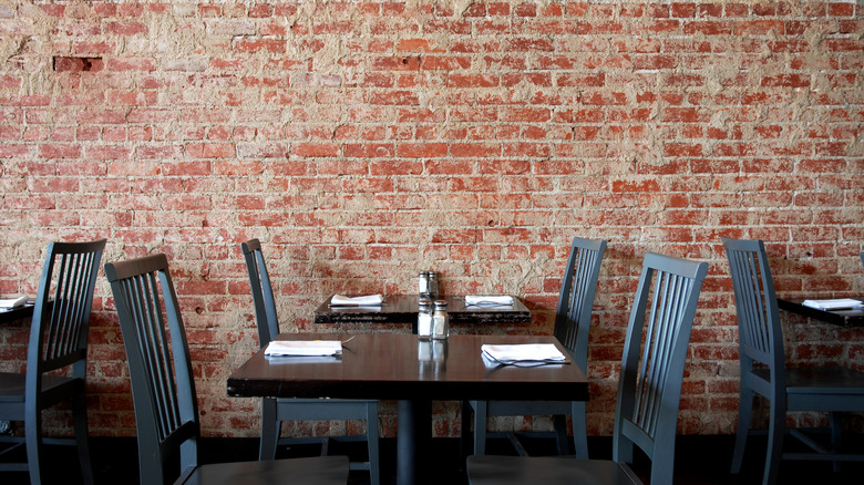 Village pub with brick wall, table, and chairs