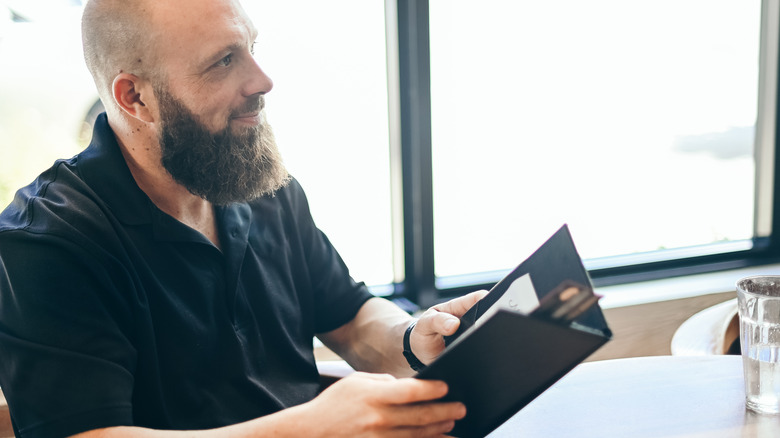 man paying bill at restaurant