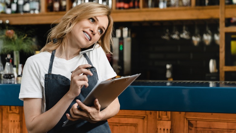 restaurant worker on phone