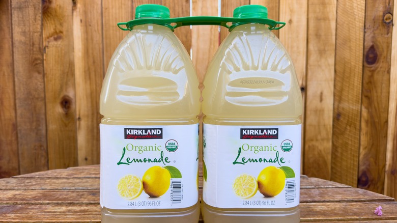 Two bottles of Kirkland Signature Organic Lemonade on wooden table.