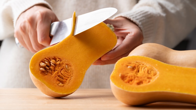 Woman cutting a butternut squash