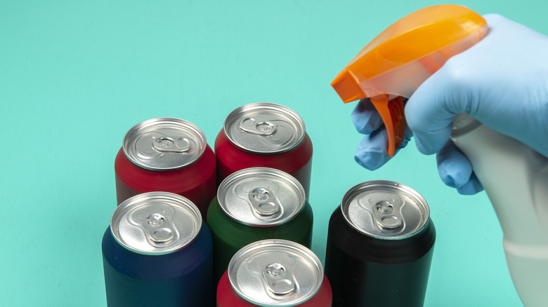 A spray gun and several soda cans