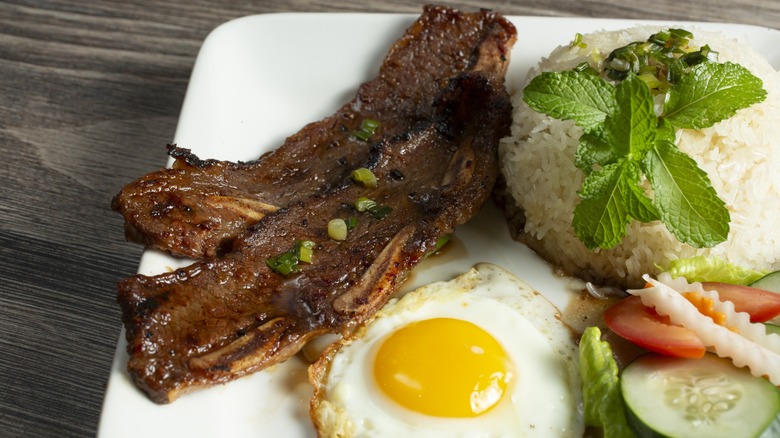 a broken rice plate with fried egg and spare ribs