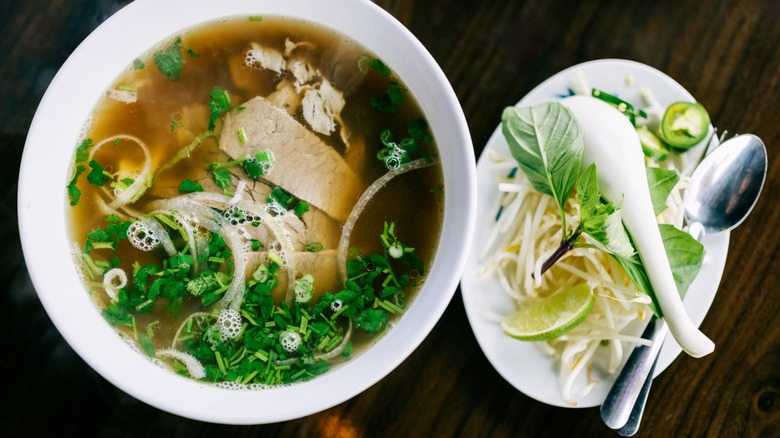 beef pho with fixings: thai basil, bean sprouts, lime, and jalepeno