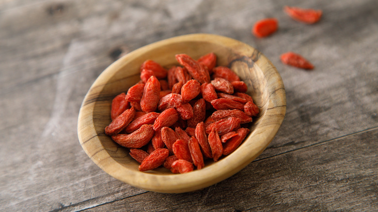 Organic goji berries in a wooden bowl