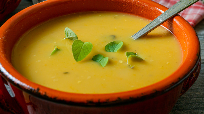 Yellow split pea soup in clay bowl