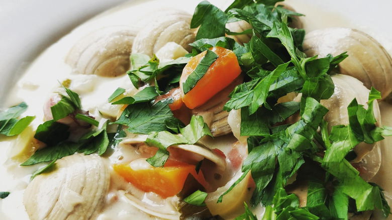 Close-up of a bowl of clam chowder with parsley
