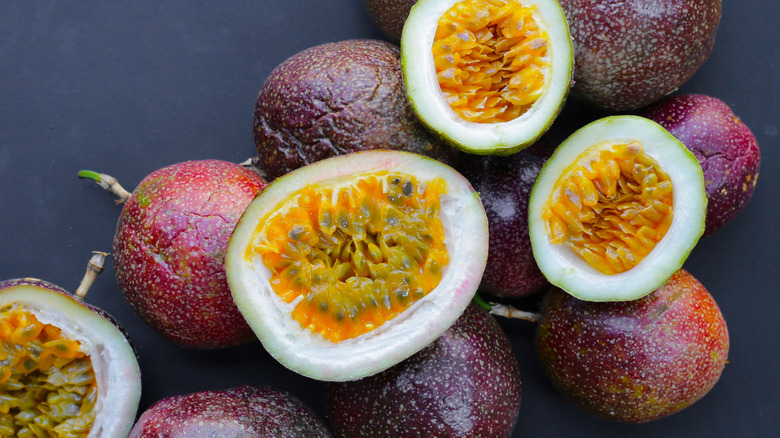 Ripe passion fruits, whole and halved