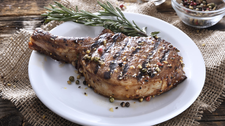pork chop and rosemary on plate