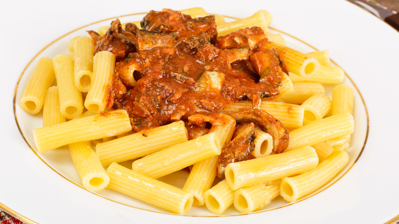 A plate of pasta with sardines and tomato sauce
