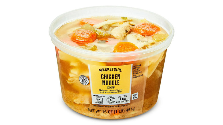Plastic container of Walmart's Marketside Chicken Noodle Soup with visible chunks of vegetables, chicken, and noodles