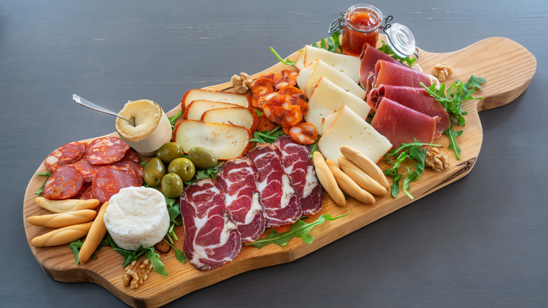 A charcuterie board with cheese