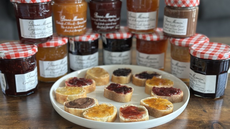 Jars of Bonne Maman flavors behind plate with assorted baguette slices