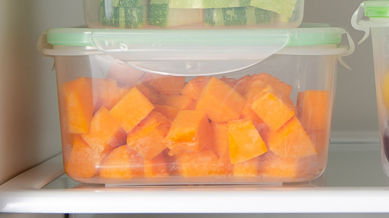 Close-iup of vegetables in plastic containers in a fridge