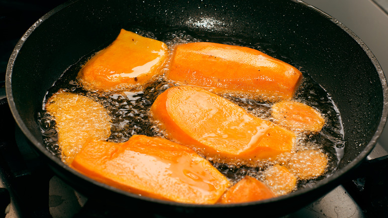 Close up of sweet potato frying in oil