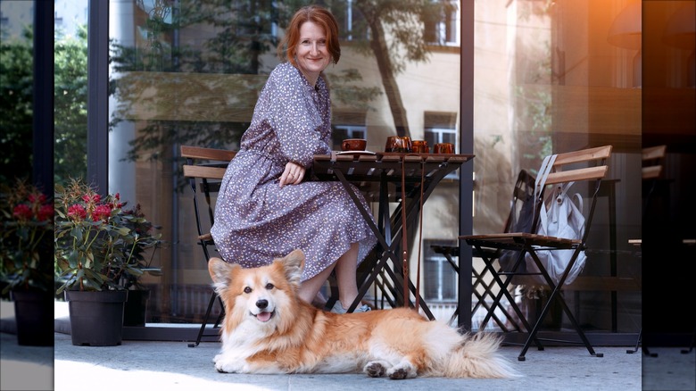 woman with dog at restaurant
