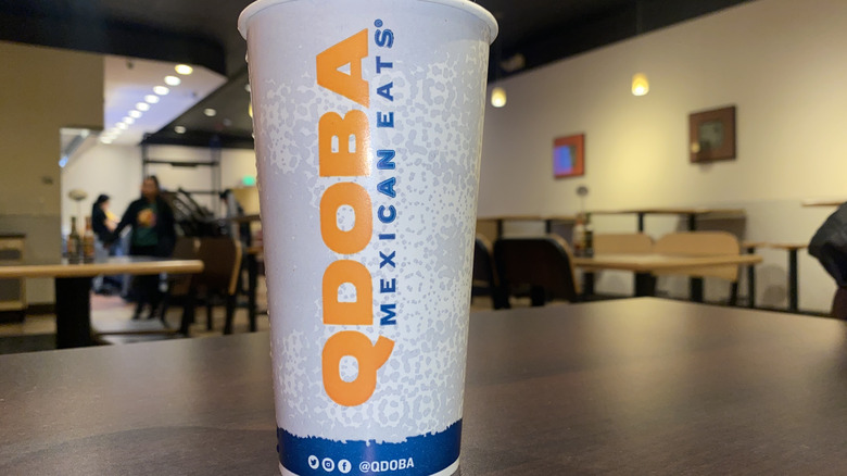 Qdoba-branded cup inside restaurant.