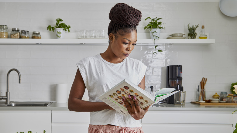 Woman reading a cookbook