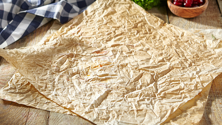Crumpled parchment paper on a wooden surface