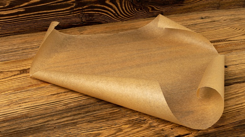 Sheet of parchment paper on a wooden surface