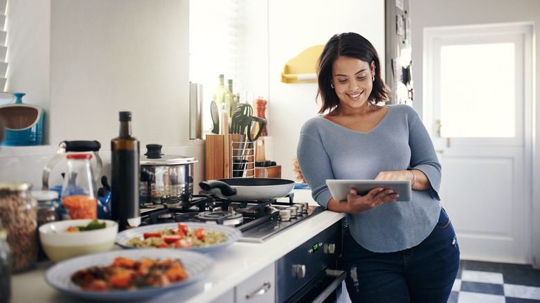 woman reading recipe in kitchen