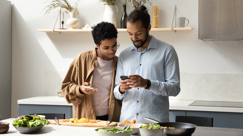 two men reading recipe