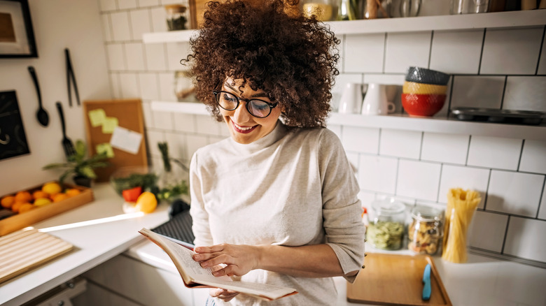woman reading recipe in kitchen
