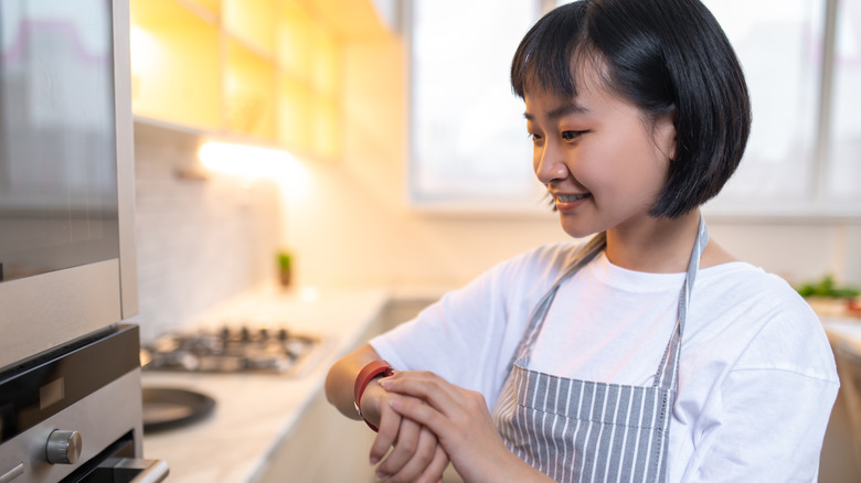 checking watch in kitchen