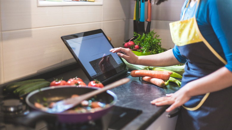 woman looking at table while cooking