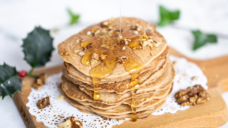 A plate of buckwheat pancakes with walnuts and honey