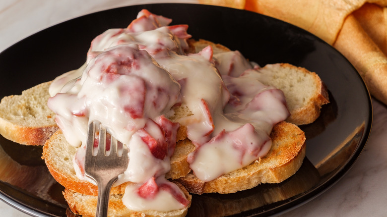 Cream chipped beef on sliced toast on marble kitchen table