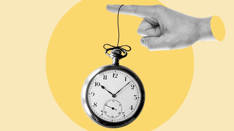 Finger with a fob watch tied to it