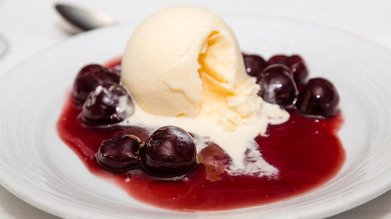 Bowl of cherries jubilee with vanilla ice cream