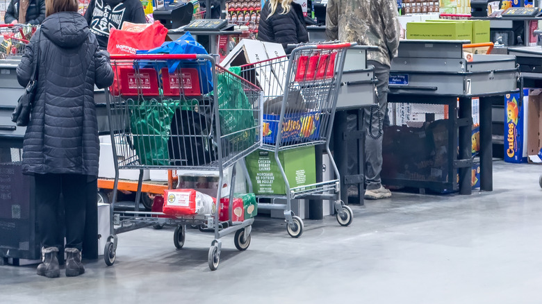 Shoppers line up at checkout counters in a Costco wholesale store