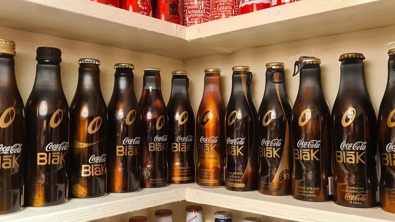 lineup of Coca-Cola Blak bottles on shelf