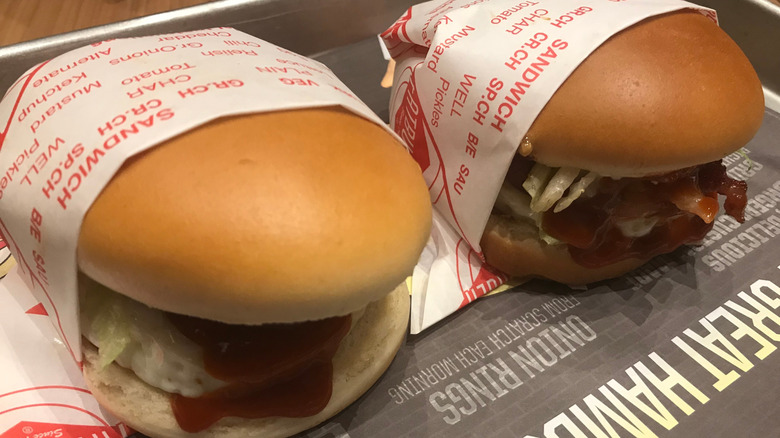 Fatburger burgers in paper sleeves on tray