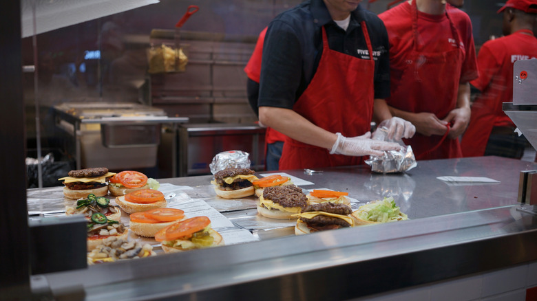 Staff at Five Guys making burgers