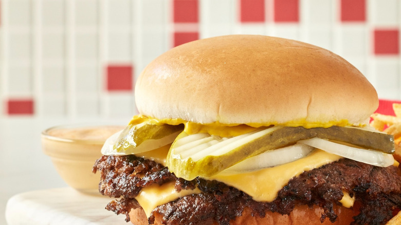 Steakburger with pickles, onion, and cheese