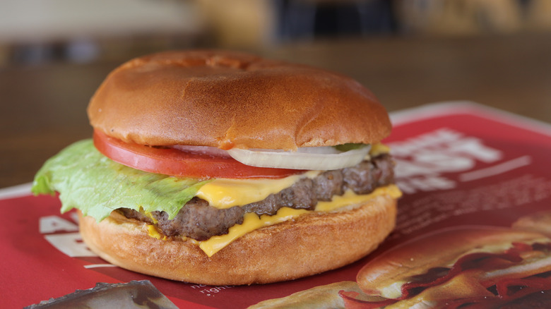 Wendy's hamburger with cheese, lettuce, tomato, and onion