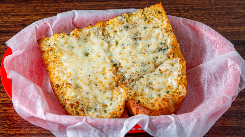 Split loaf of garlic bread with melted cheese
