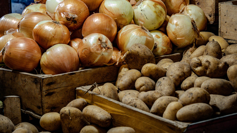 Piles of onions and potatoes