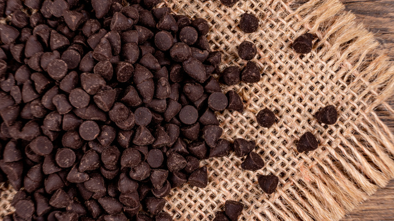 Dark chocolate chips on burlap fabric