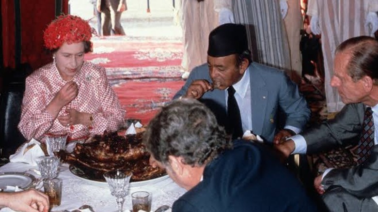 Queen Elizabeth II eating food with her hands during a 1980 state visit to Morocco