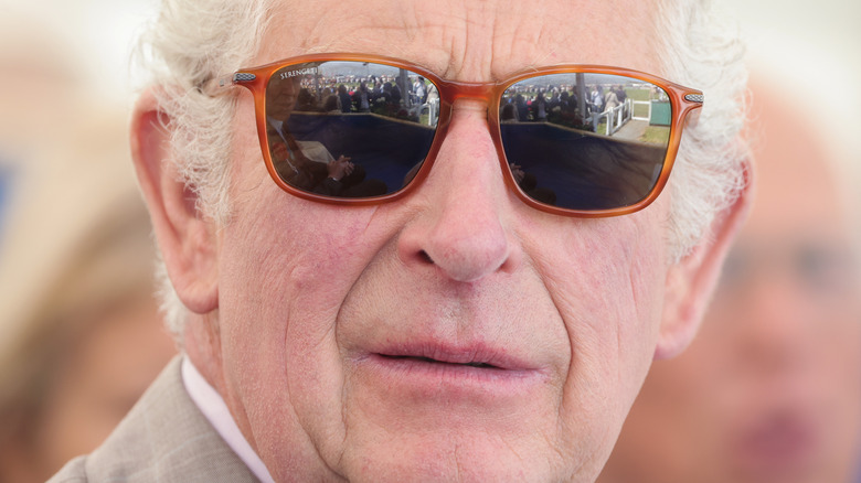 A close-up of King Charles wearing sunglasses